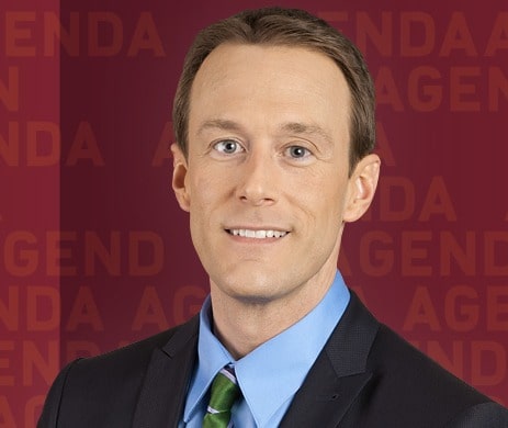 Brent Goff posing for a photoshoot by wearing black suit.